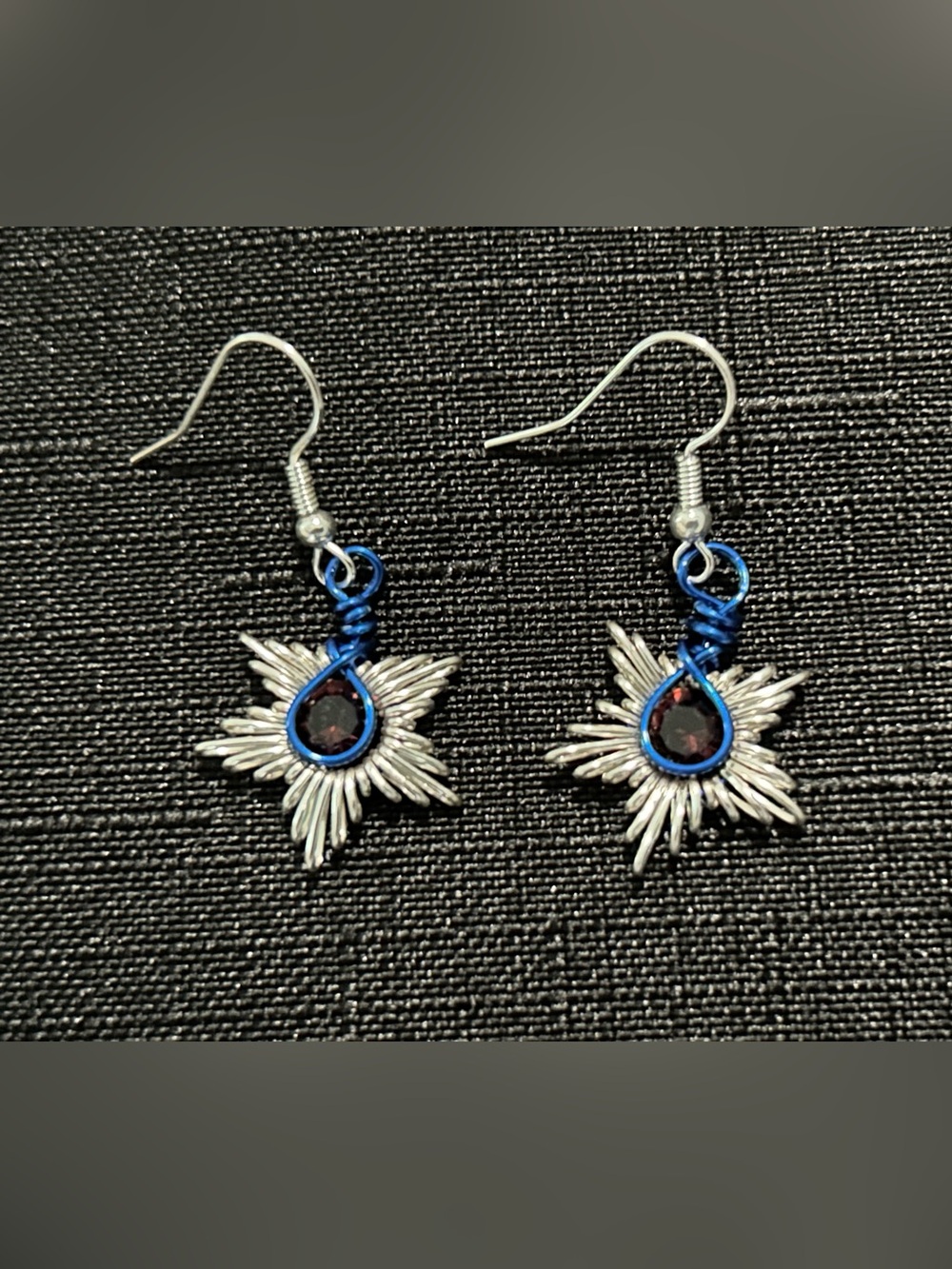 Silver Starburst Earrings with Blue Accent and Dark Red Gem